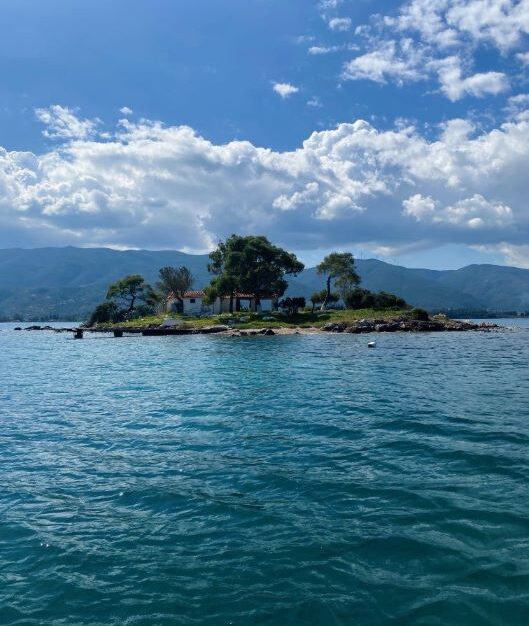 Saronic islands boat tours - No license boat rental in Poros near Love Bay with turquoise waters and pine trees